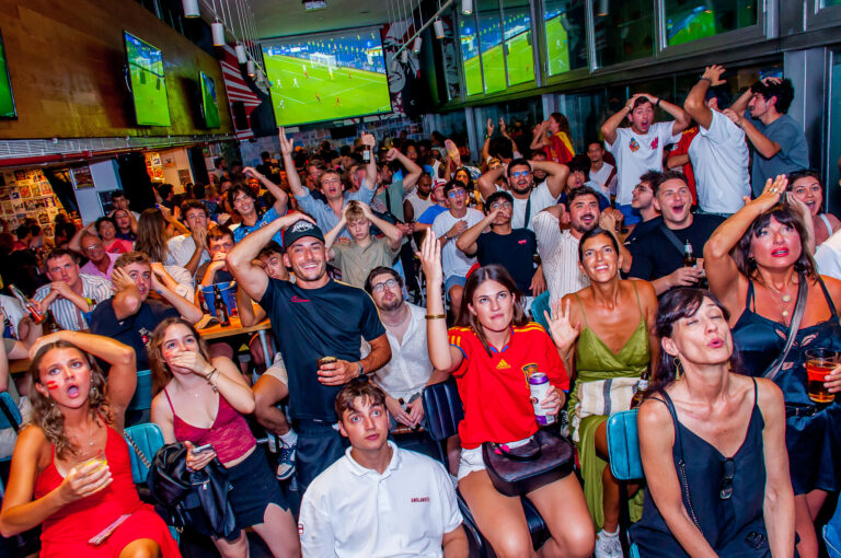 Fans enjoying a football match in a Belushi's bar